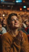 Audience member expresses joy and appreciation during a live performance at an indoor venue in the evening photo