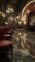 Abandoned theater showcasing elegant design and decay during twilight hours with reflections on the wet floor photo