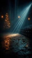 Flickering lights highlight a festive tree in a dimly lit theater with empty seats during a winter evening event photo