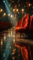 Elegant red chairs lined up in a dimly lit hall reflecting warm lights during a special event in the evening photo