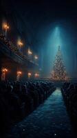 People enjoying a festive event in a theater with a large Christmas tree illuminated in the center during the holiday season photo