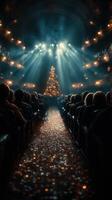 Audience enjoying a festive performance with a sparkling Christmas tree glow in the background at a theater during a winter evening photo