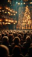 Audience captivated by performance in a theater with warm lighting and festive decorations during winter evening photo