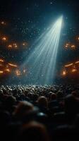 Crowd gathered in theater under spotlight during a performance filled with anticipation and excitement photo
