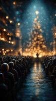 Crowd gathers for a festive celebration in a beautifully decorated hall with a glowing Christmas tree at night photo