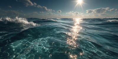 Calming ocean waves sparkle under the bright sun during midday with clouds scattered in the sky photo