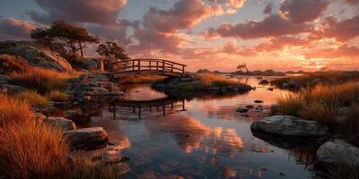 Sunset over tranquil river with wooden bridge and rocky landscape in natural setting photo