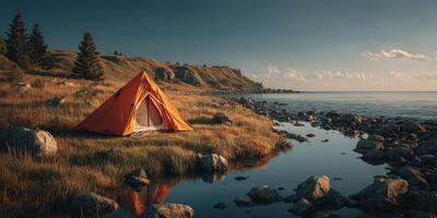 Bright orange tent set up by a tranquil lake during a golden hour in a scenic nature landscape photo
