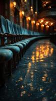 Elegant vintage chairs lined up in a dimly lit hallway reflecting warm light at an evening event photo