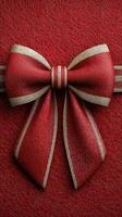 Elegant red ribbon bow on textured wrapping paper for gift giving during celebratory occasions photo