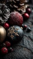 Decorative ornaments and pinecones arranged on a rustic stone surface for holiday celebrations during winter season photo