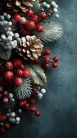 Decorative holiday arrangement featuring red berries, pinecones, and artificial snow on a textured dark background photo