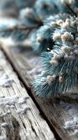 Winter landscape with snow-covered pine branches on rustic wooden surface photo