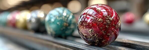Colorful glass marbles lined up on a surface in an artistic display during a sunny afternoon photo