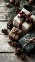 Cozy holiday gifts wrapped in natural materials with pinecones and evergreen branches on rustic wood photo