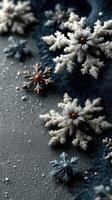 Snowflakes arranged on a textured surface with a dark blue background creating a winter-themed display near the holiday season photo