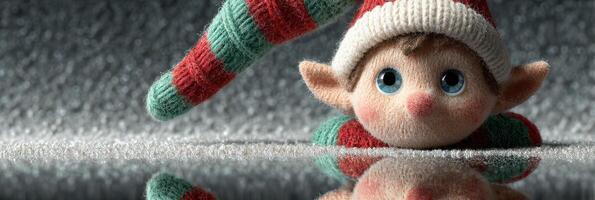 Cute elf with big eyes hides behind a festive background while reflecting on the surface during a holiday setting photo