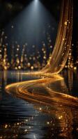 Glowing golden fabric flowing over a reflective surface surrounded by sparkling lights in a dimmed space photo