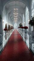 Elegant holiday corridor adorned with festive decorations and a red carpet in a grand building during winter celebration photo