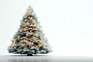 Frosted Christmas tree with warm lights and ornaments set against a white background during the holiday season photo