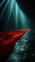 Red waves shimmer under soft blue lights in a dark, tranquil water setting at dusk photo