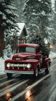 Vintage red truck carries a Christmas tree through snowy road in winter wonderland at dusk photo
