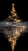 Sparkling Christmas tree reflecting on a dark, misty surface during a festive atmosphere photo