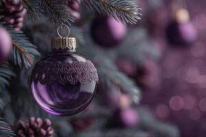 Decorative purple ornament hanging on a Christmas tree with soft bokeh background during the holiday season photo