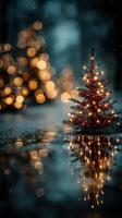 Christmas tree reflecting in water with festive lights and bokeh in winter scenery at night photo