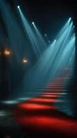 Dramatic entrance with red carpet illuminated by soft blue lights in a dimly lit venue photo