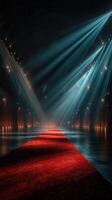 Elegant red carpet leading to a spotlight in a grand, dimly lit venue showcasing exquisite lighting effects photo