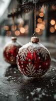 Festive red ornaments hanging under snowflakes with warm lights in the background at a winter market photo