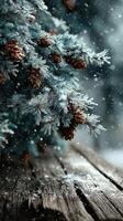 Snowfall gently covers conifer branches with pine cones resting on a rustic wooden surface in a serene winter setting photo
