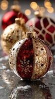 Christmas ornament decorated with red and gold design on reflective surface photo