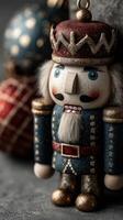 Colorful nutcracker figurine stands proudly beside festive ornaments during holiday season in a cozy indoor setting photo