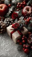 Elegant holiday gift wrapped in burlap with red flowers and decorative elements on a festive table photo
