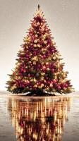 Festive Christmas tree adorned with ornaments and lights in a snowy winter setting reflecting on a serene surface photo