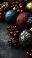 Festive decorations with shiny ornaments, pinecones, and aromatic spices arranged on dark textured surface during the holiday season photo