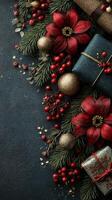 Decorative holiday arrangement with gifts, berries, and flowers on a dark surface photo