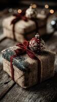 Rustic holiday gifts wrapped in burlap with red ribbons and decorative ornaments on wooden surface photo