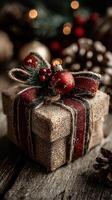 Beautifully wrapped Christmas gift with decorative elements displayed on rustic wooden surface photo