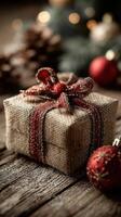 Festively wrapped gift box with rustic decoration and ornaments on wooden table photo