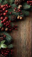 Festive holiday decorations featuring pine branches and red berries on rustic wooden surface photo