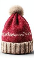 Warm red knit hat with pom pom displayed on a white background for winter fashion inspiration photo