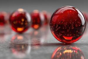 Red glass spheres reflecting light on a smooth surface in an artistic composition photo
