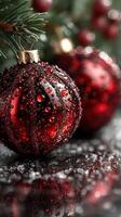 Beautiful red Christmas ornaments with droplets reflecting light during the holiday season photo