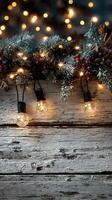 Decorative string lights illuminate rustic wooden surface with festive greenery during a cozy winter evening photo