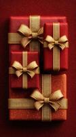 Festive red and gold gift boxes arranged on a textured surface ready for celebration during holiday season photo