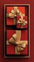 Elegant red gift boxes with golden ribbons arranged on a textured surface, perfect for celebrations and special occasions photo