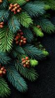 Lush green pine branches adorned with colorful berries and blooms on a dark textured surface photo